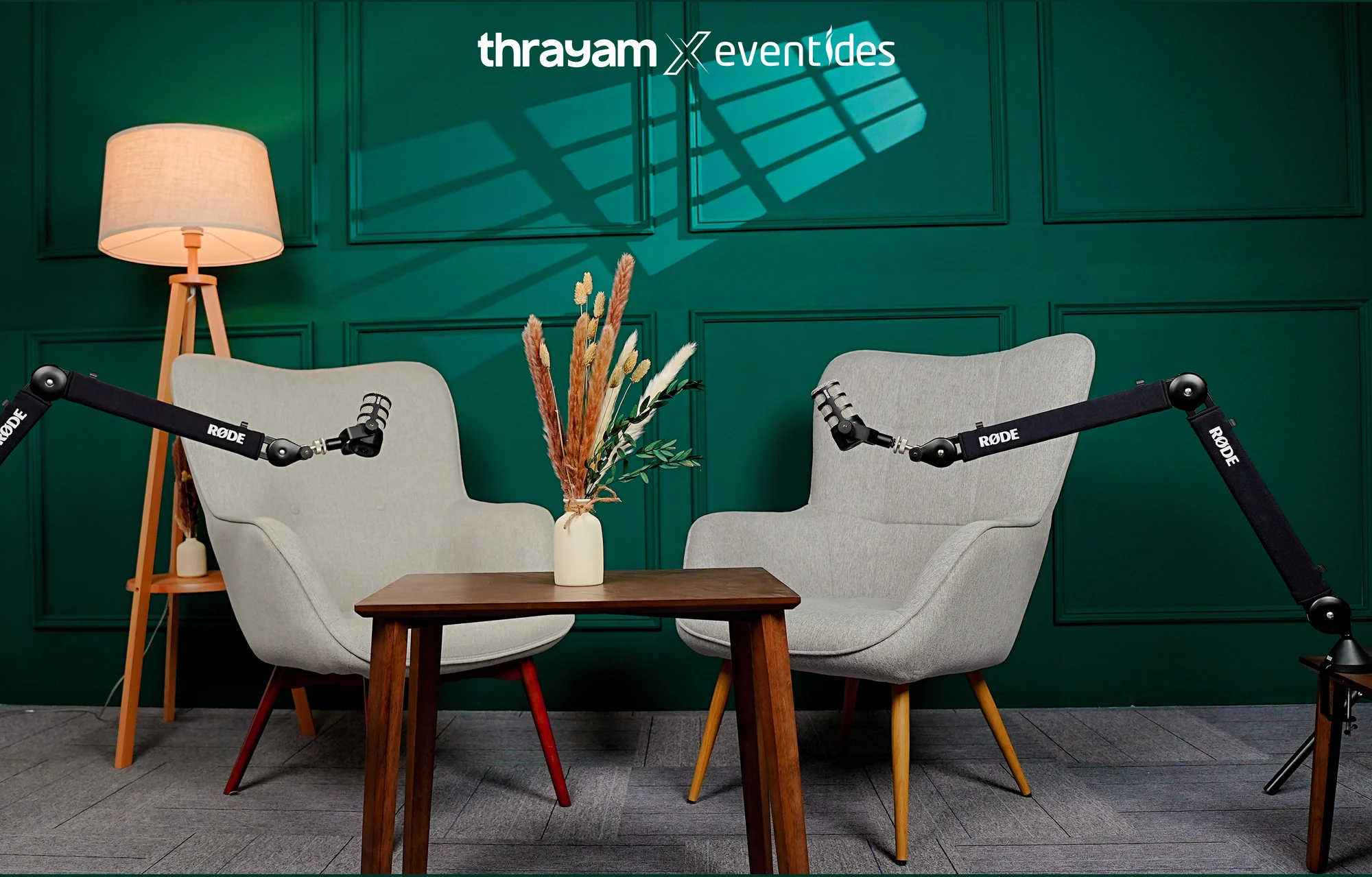 Green podcast set with two chairs and two RØDE microphones inside the Thrayam studio